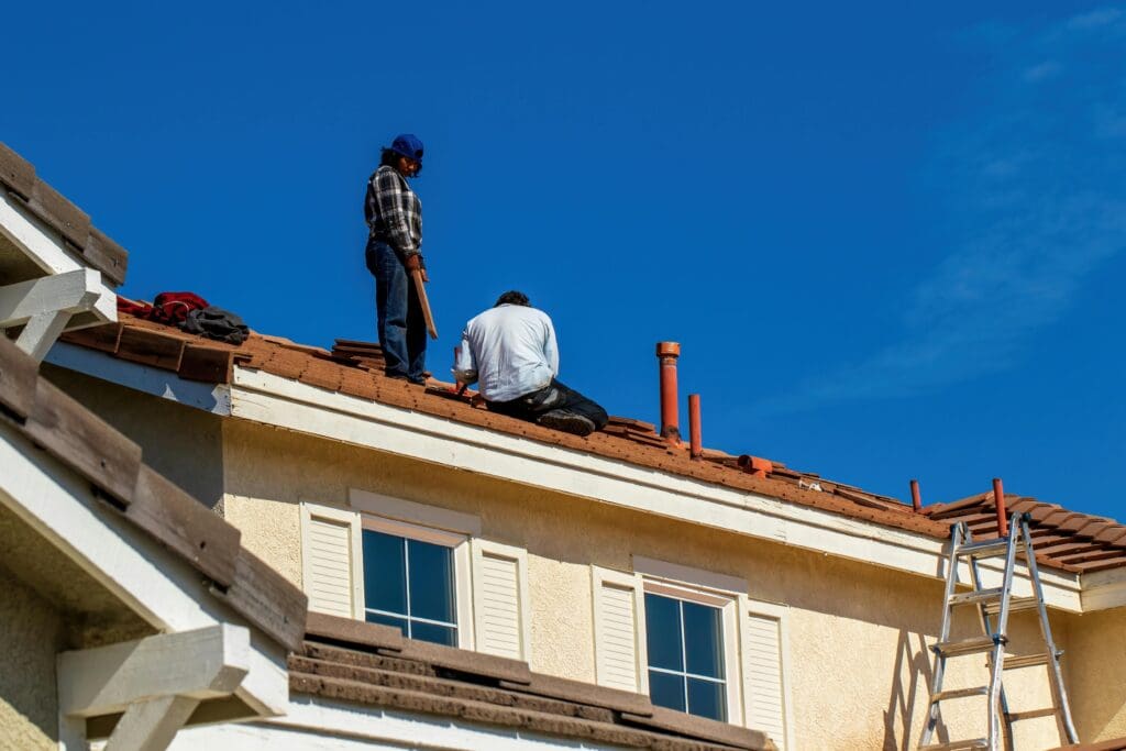 Two workers on tiled roof